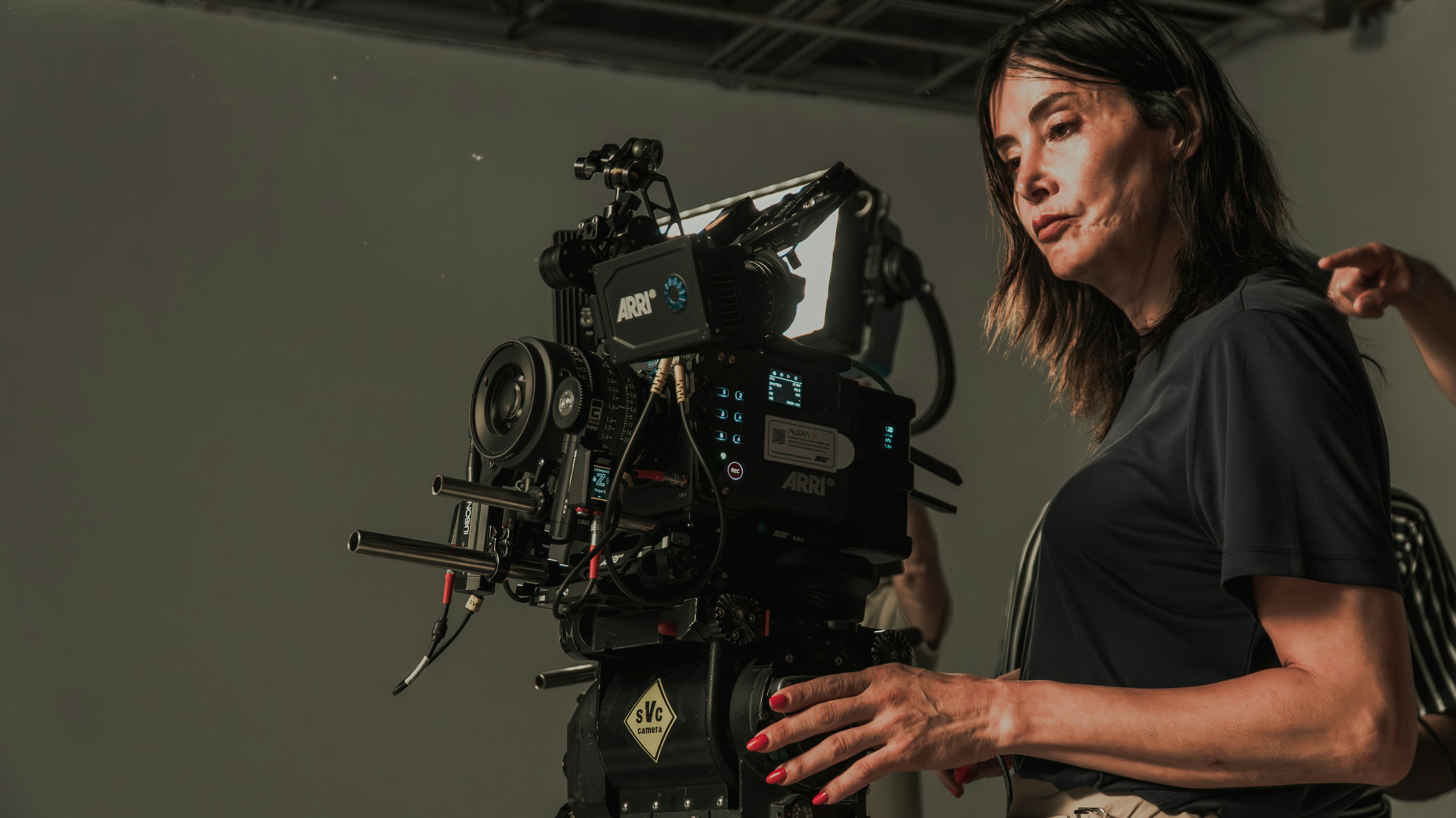 Professional camera operator working with a cinema camera on a studio set.